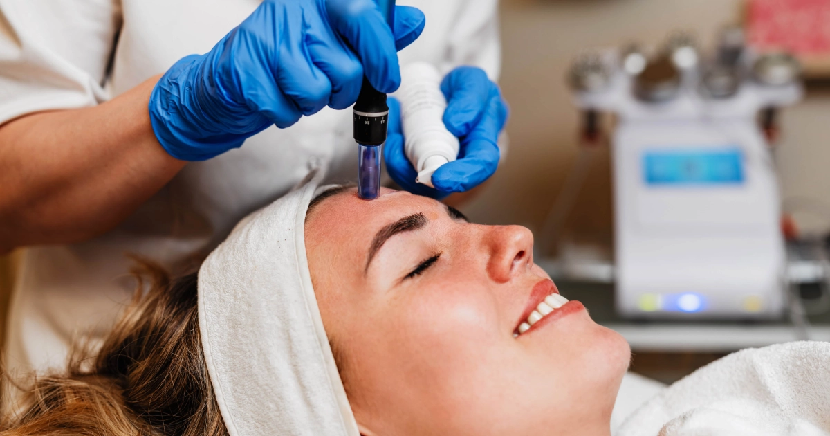 Woman receives Microneedling with PRF in Lake Charles, LA from a professional in blue gloves.