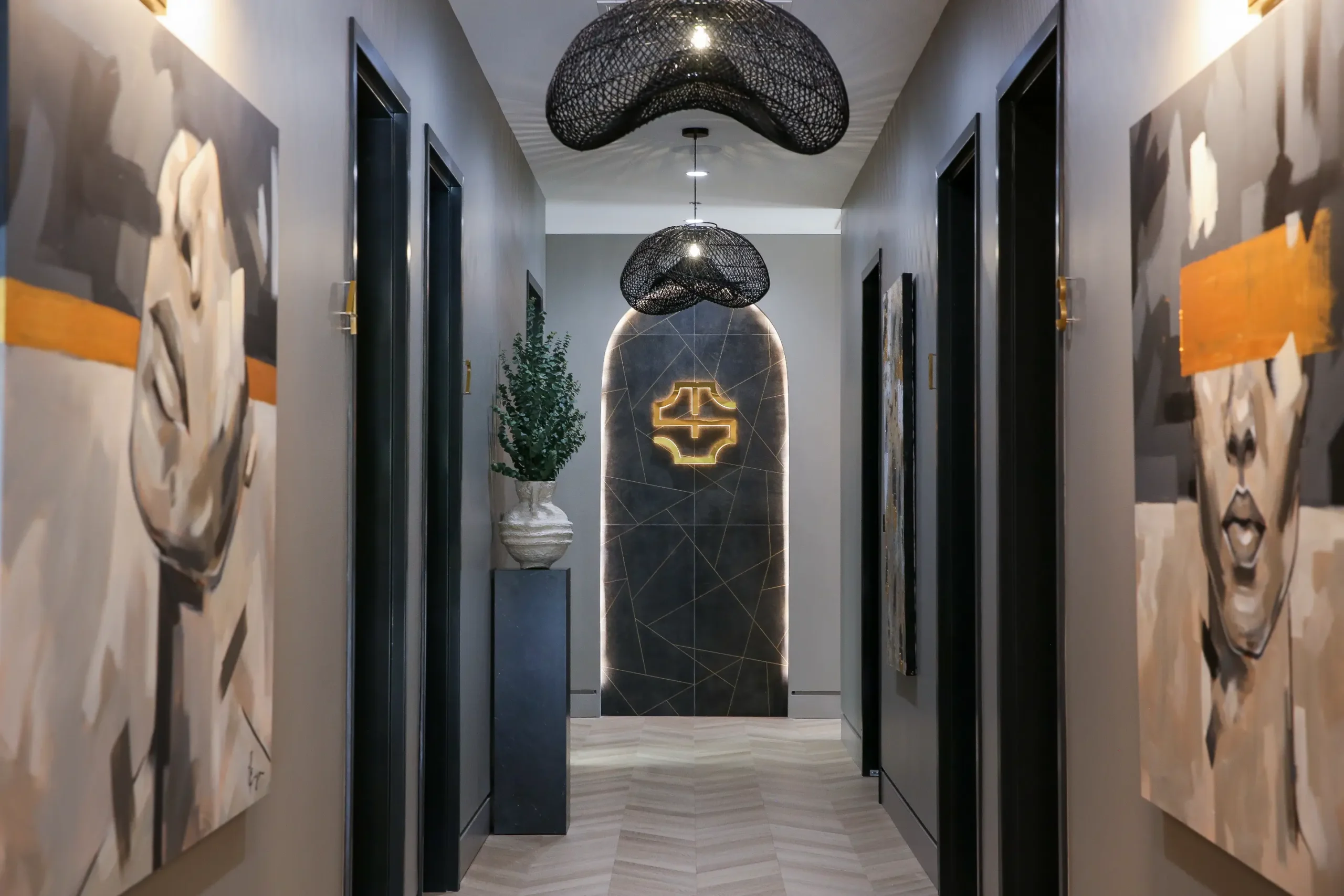 a hallway with black and gold lights