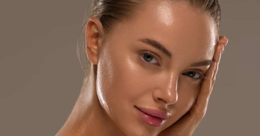 Woman with radiant, glowing skin gently touching her face, showcasing the smooth and youthful results of Chemical Peels in Lake Charles, LA.